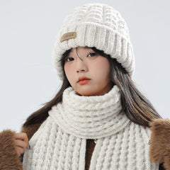 Beige knit hat and scarf set displayed on a white background