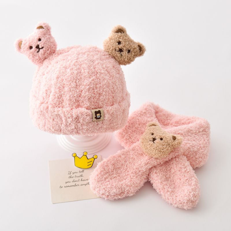 Baby model wearing a beige bear hat and scarf set