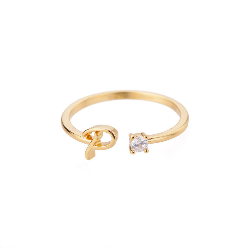 close-up of gold plated alphabet ring
