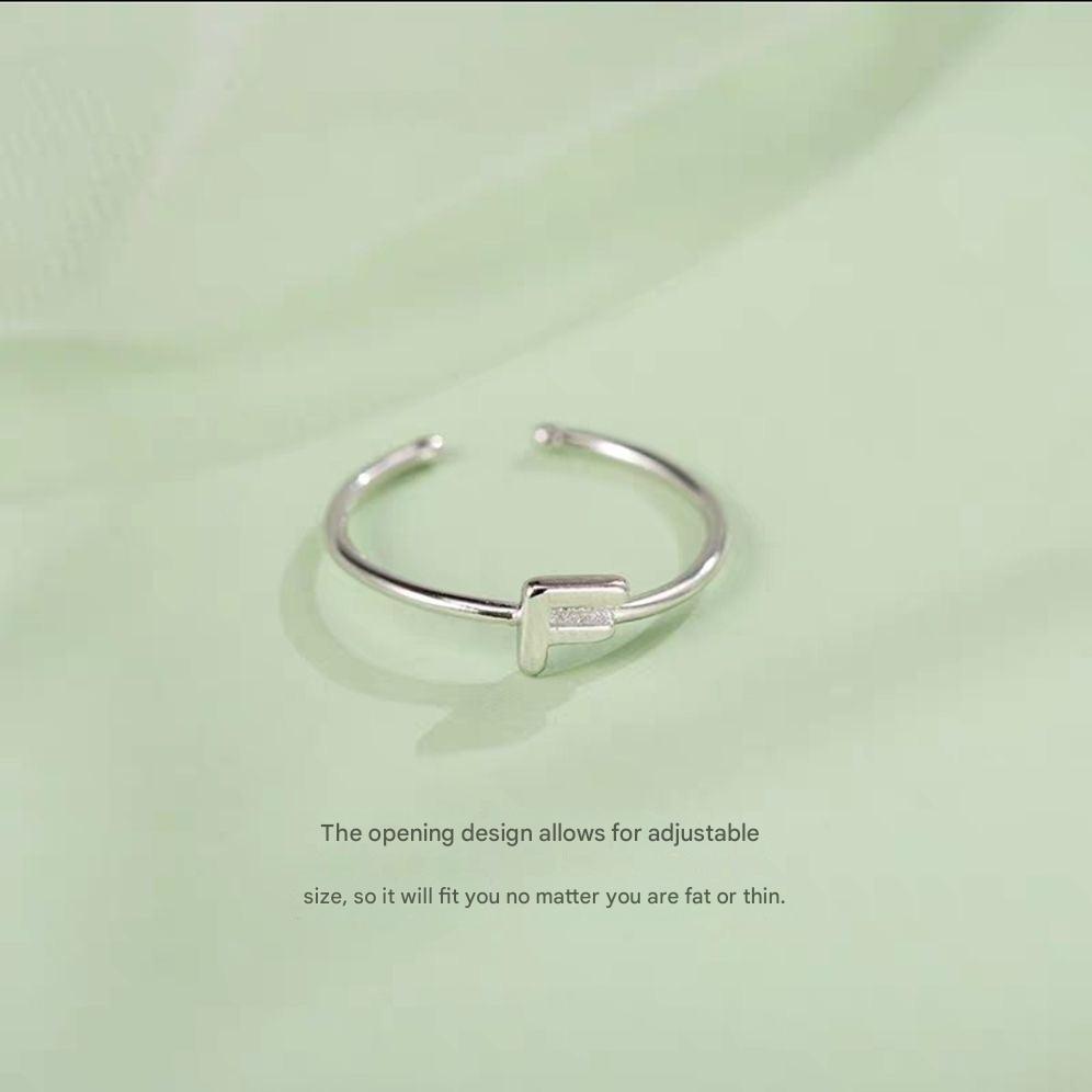 Stylish Adjustable Silver Alphabet Ring on display