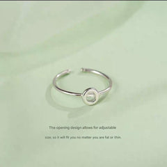 Stylish Adjustable Silver Alphabet Ring on display