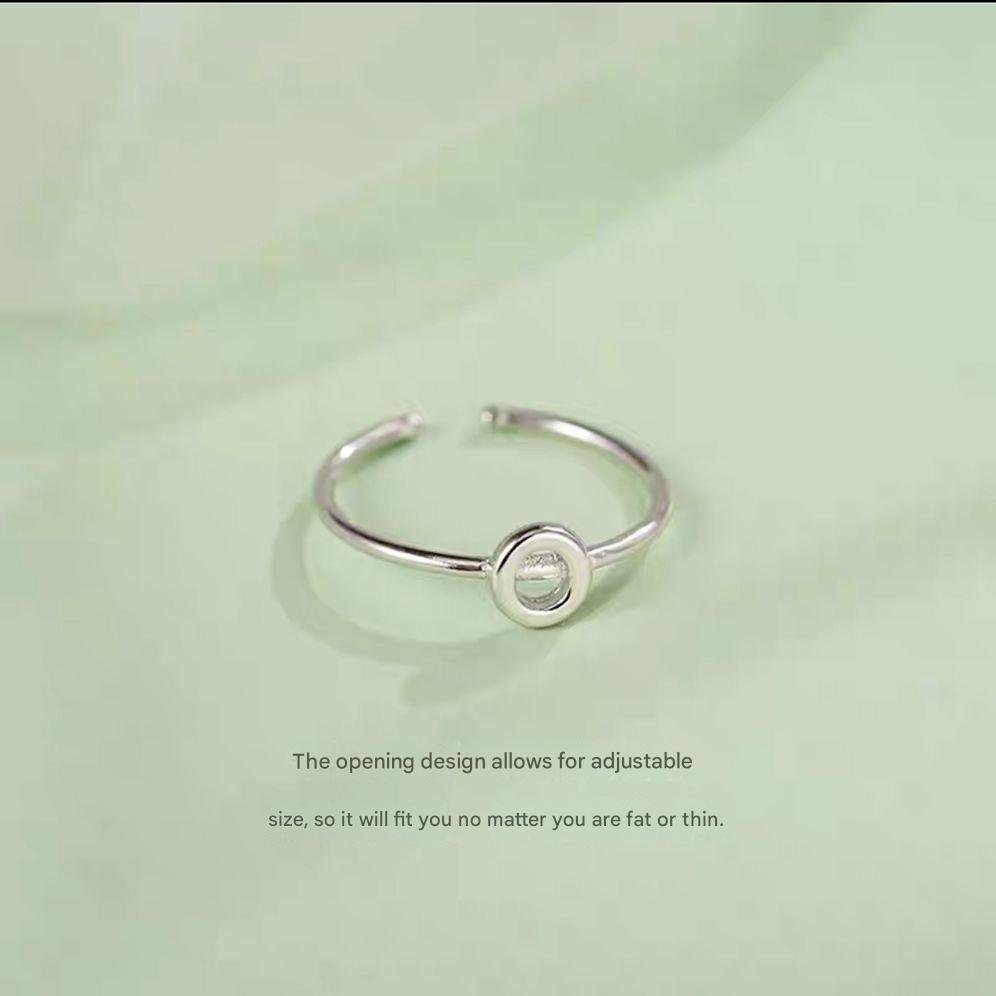 Stylish Adjustable Silver Alphabet Ring on display