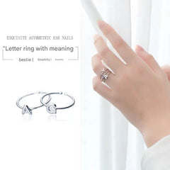 Stylish Adjustable Silver Alphabet Ring on display