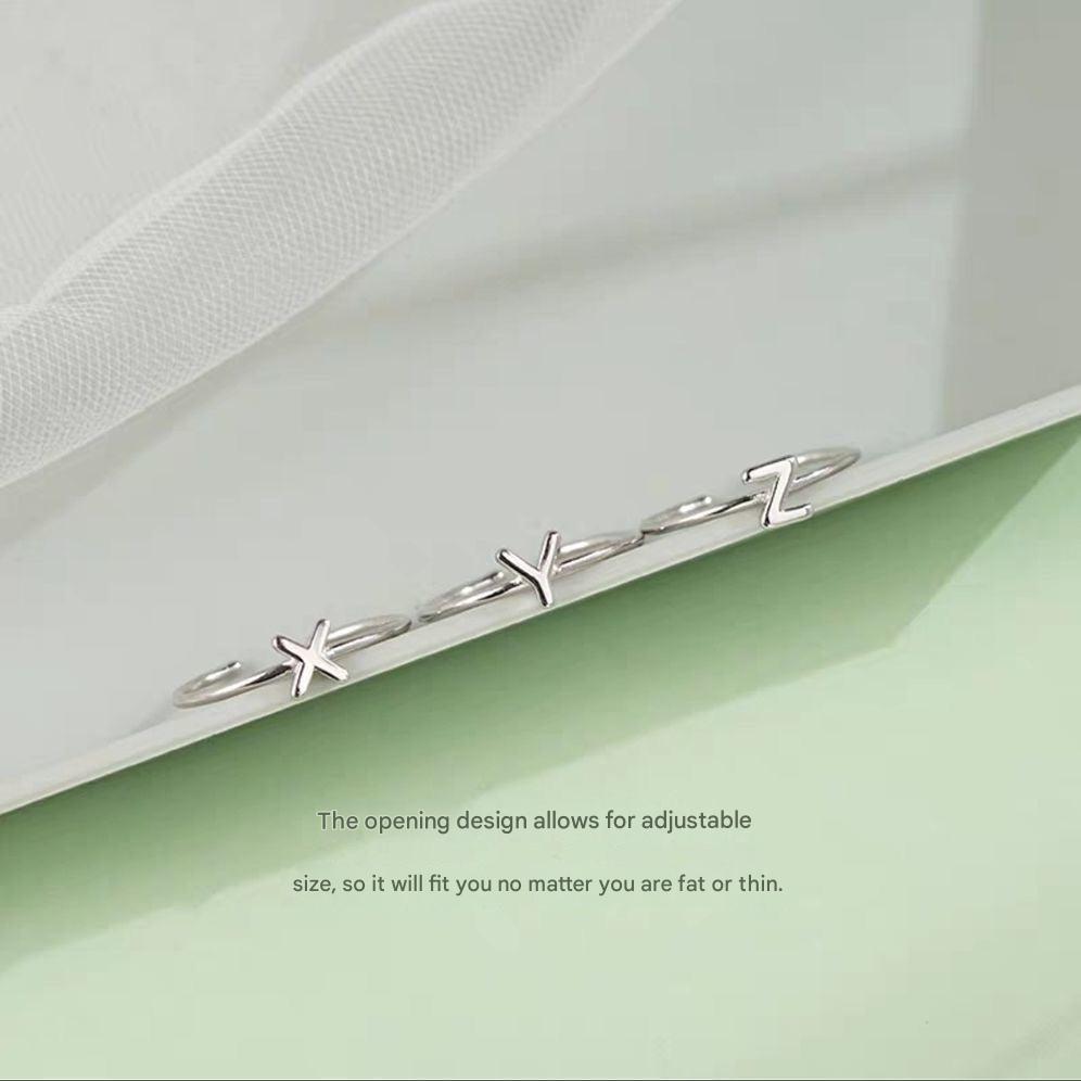 Stylish Adjustable Silver Alphabet Ring on display