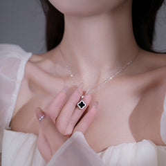 Image of the clover necklace against a plain backdrop