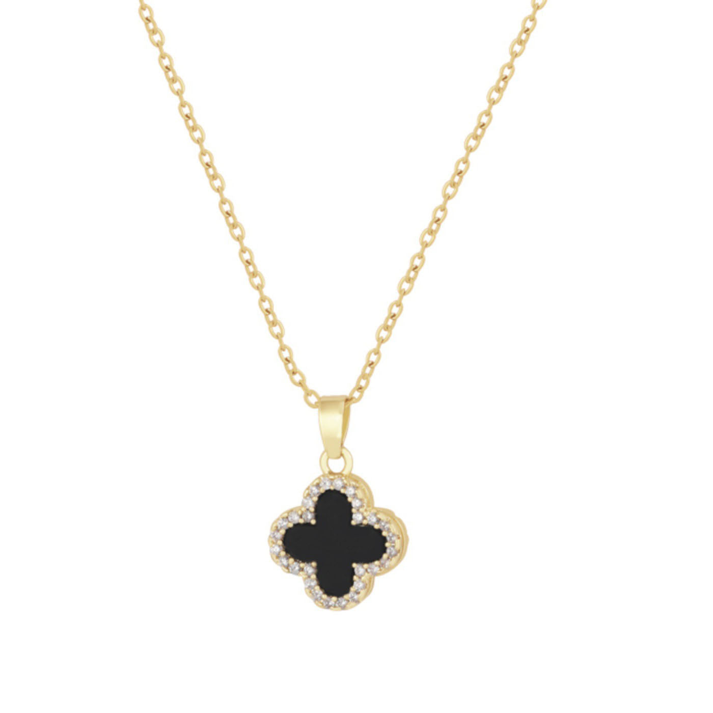 Four-leaf clover necklace lying on a marble surface