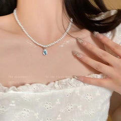 Close-up of blue waterdrop pearls on necklace