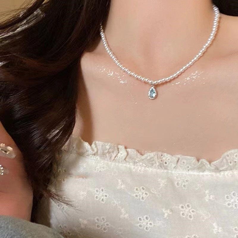 Model wearing blue waterdrop pearl necklace
