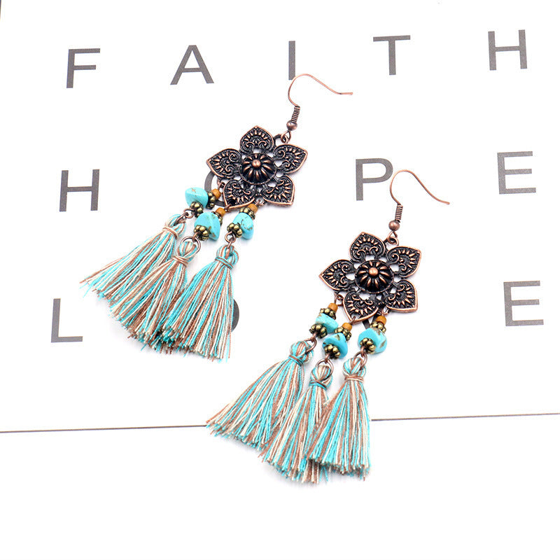 women wearing matching outfit with tassel earrings