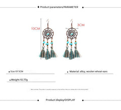 stylish earrings placed on a soft fabric background