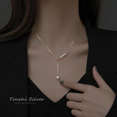 Close-up of pearl detailing on the silver necklace