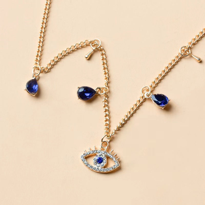Gold-Plated Crystal Evil Eye Necklace on a necklace stand
