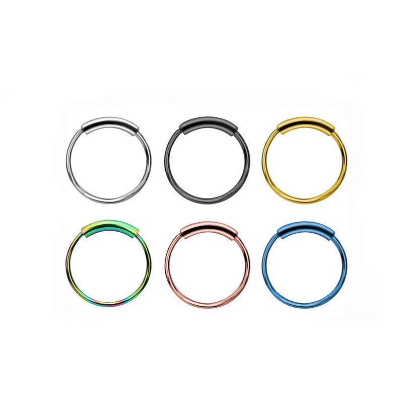 Close-up view of stylish nose ring and earrings set in stainless steel