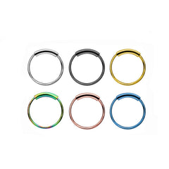 Close-up view of stylish nose ring and earrings set in stainless steel