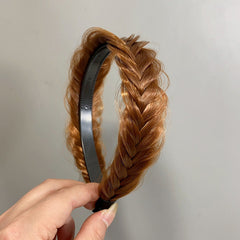 Wide hair accessory laid out against a white background