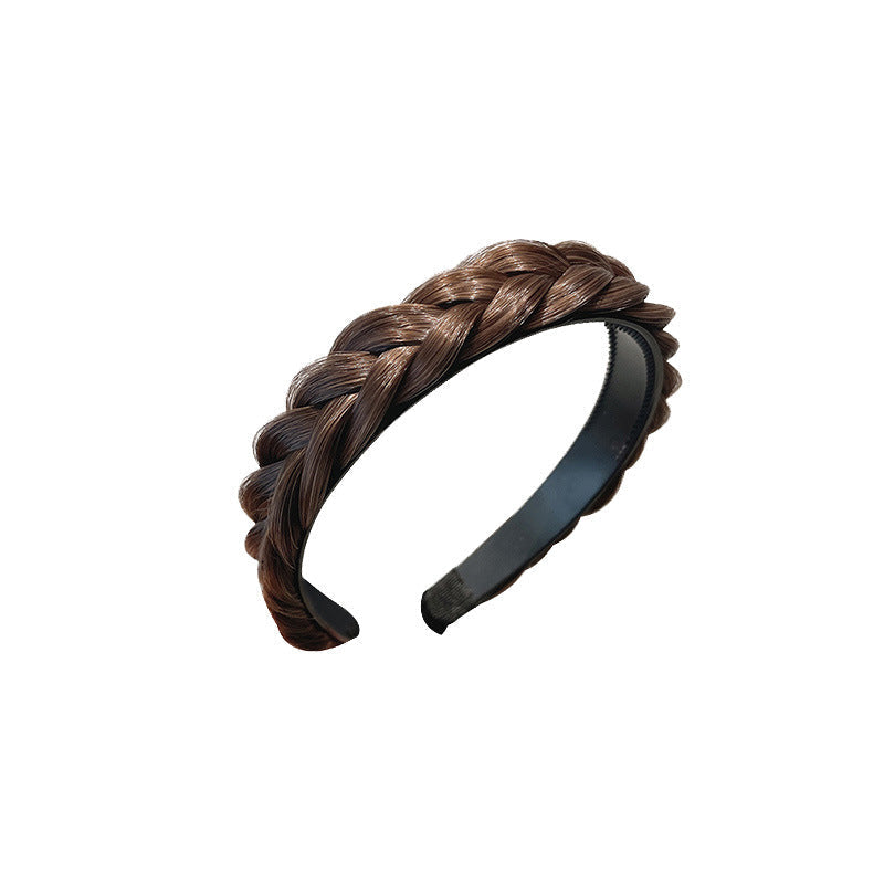Wide hair accessory laid out against a white background