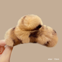 Close-up of stylish claw clip for hair with rabbit fur