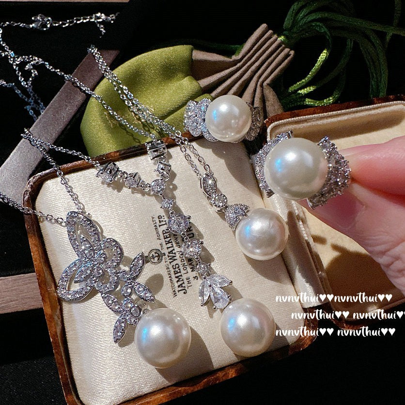 Close-up of butterfly design on gemstone pearl necklace
