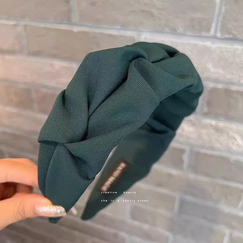 Close-up of stylish wrinkled wide hairband fabric