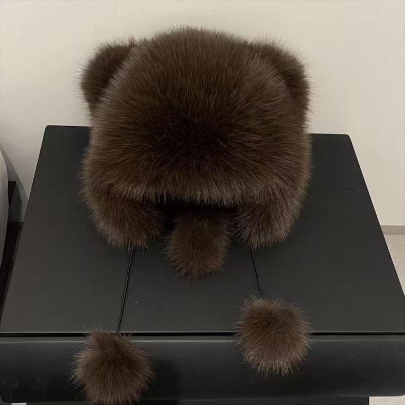 Cute plush winter hat with bear ears winter background