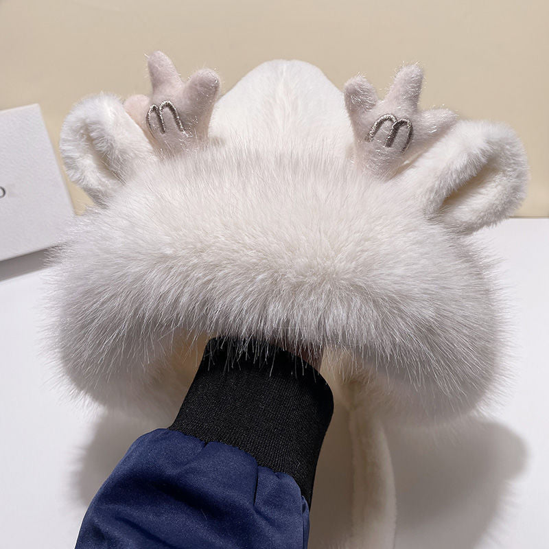 Close-up of pom poms on winter hat with antlers