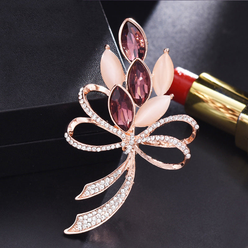 Elegant heart-shaped rhinestone brooch on white background