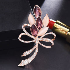 Elegant heart-shaped rhinestone brooch on white background