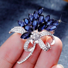 Stylish floral design brooch displayed on a cloth