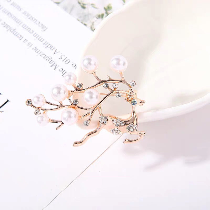 Elegant heart-shaped rhinestone brooch on white background