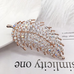 Stylish floral design brooch displayed on a cloth