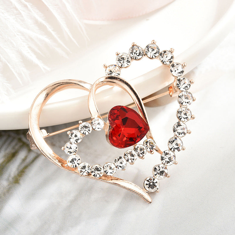 Heart-shaped brooch shining with colorful rhinestones
