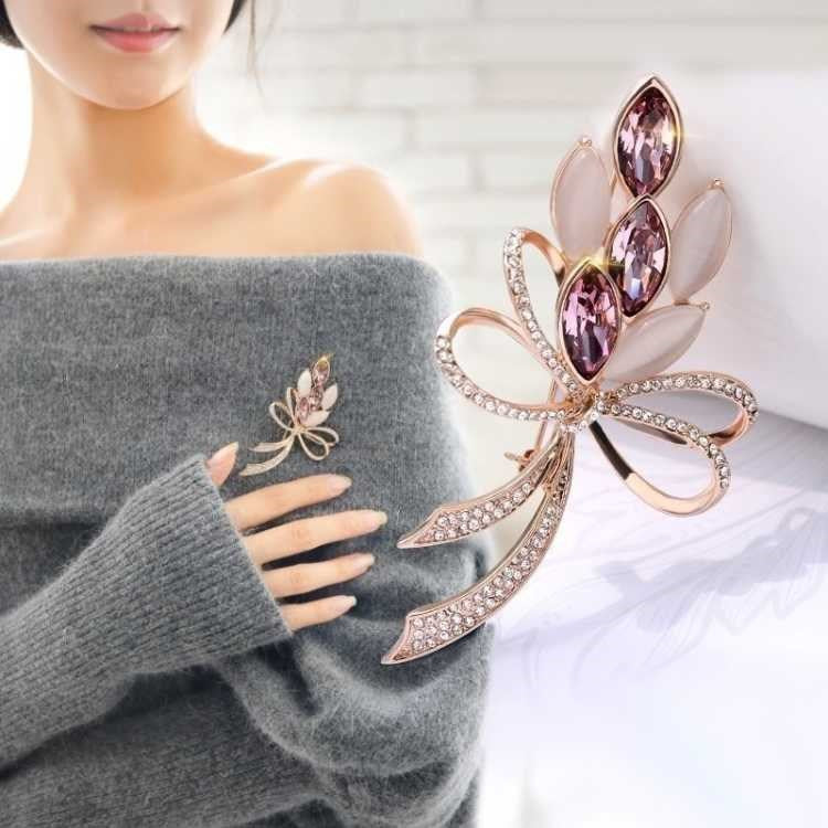 Stylish floral design brooch displayed on a cloth