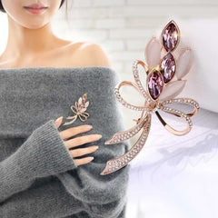 Stylish floral design brooch displayed on a cloth