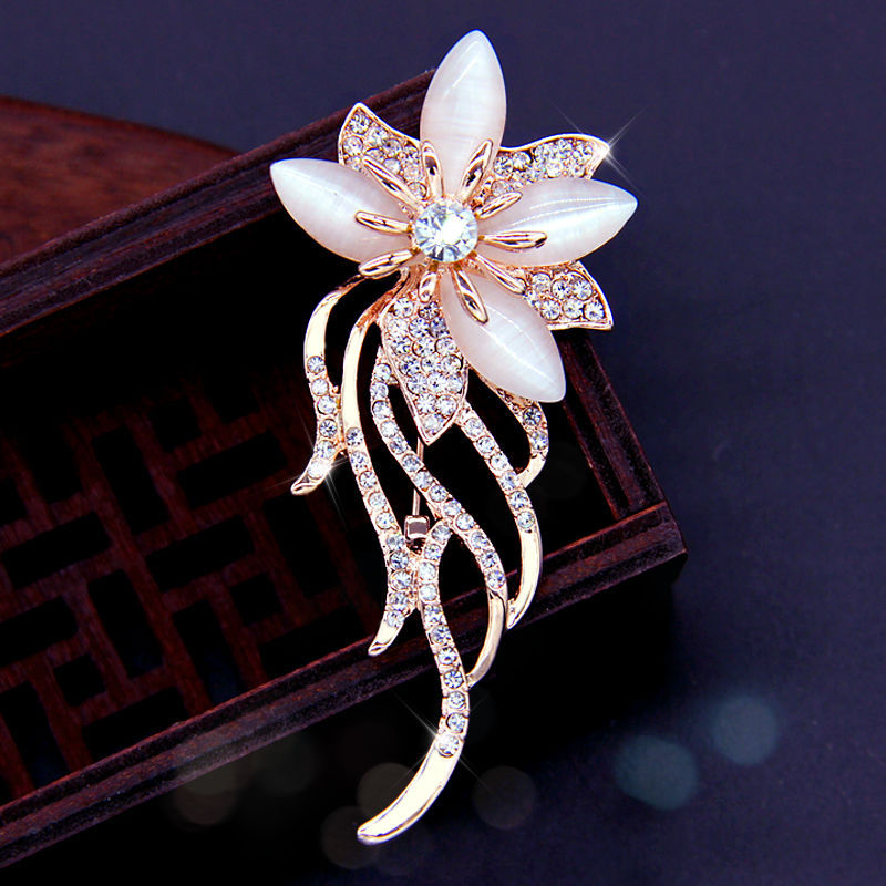 Stylish floral design brooch displayed on a cloth
