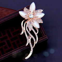 Stylish floral design brooch displayed on a cloth