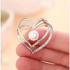 Elegant heart-shaped rhinestone brooch on white background