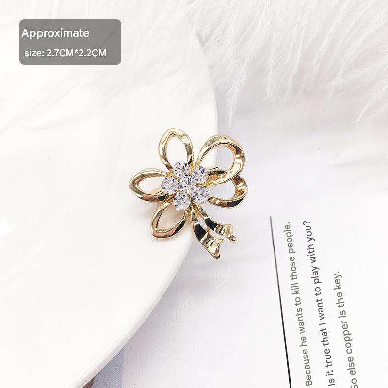 Elegant heart-shaped rhinestone brooch on white background