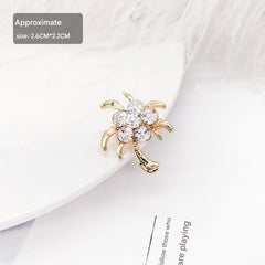 Stylish floral design brooch displayed on a cloth