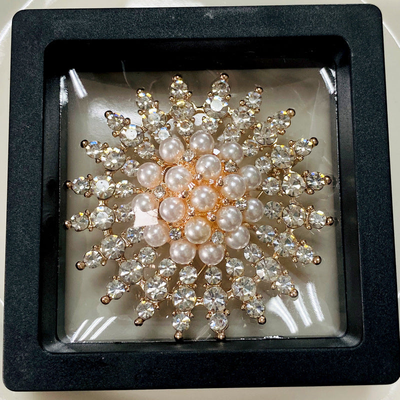 Close-up of intricate rhinestone detailing on brooch