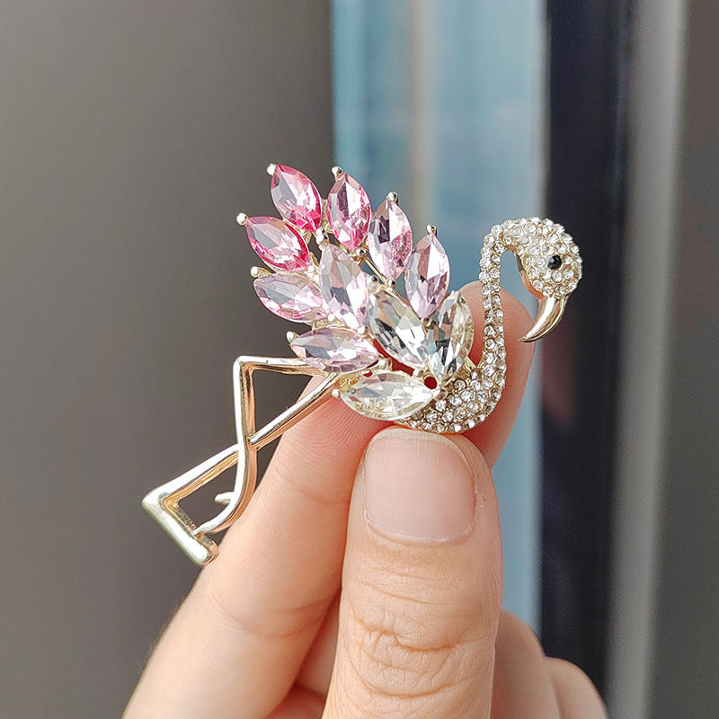 Flamingo crystal brooch worn as a fashion accessory