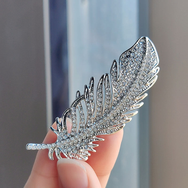 close-up view of rhinestone accents on the feather brooch