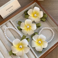 Floral egg clips displayed on a beach background