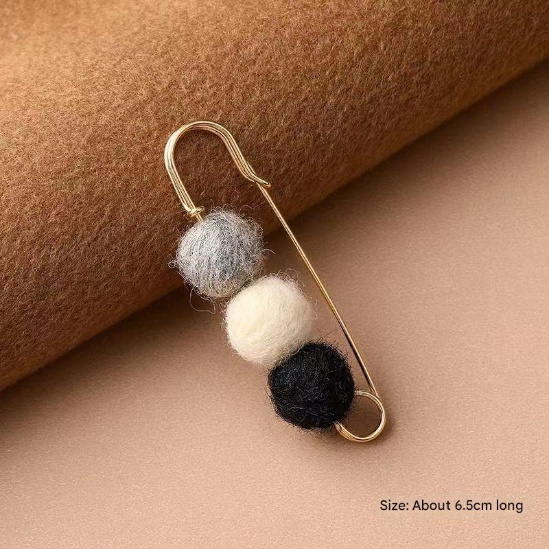 Pink cardigan brooch styled with winter wear